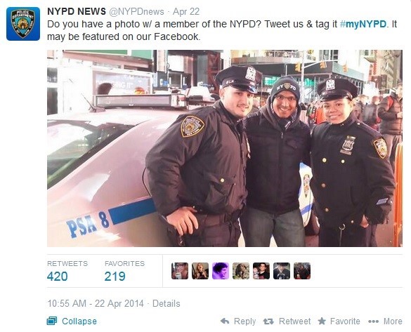 Man smiling and posing with two NYPD officers. 